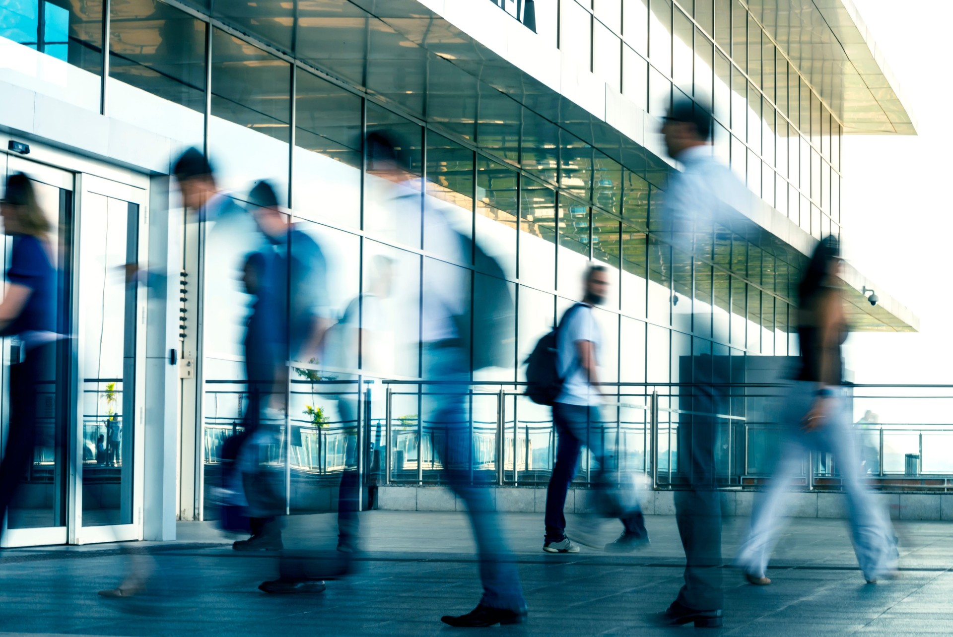 People walking in front of a modern building.
